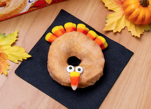 Add candy corns and candy eyes to Pumpkin Donuts to create a fun turkey character.